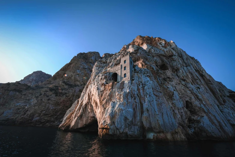 the top of a rock tower in a lake