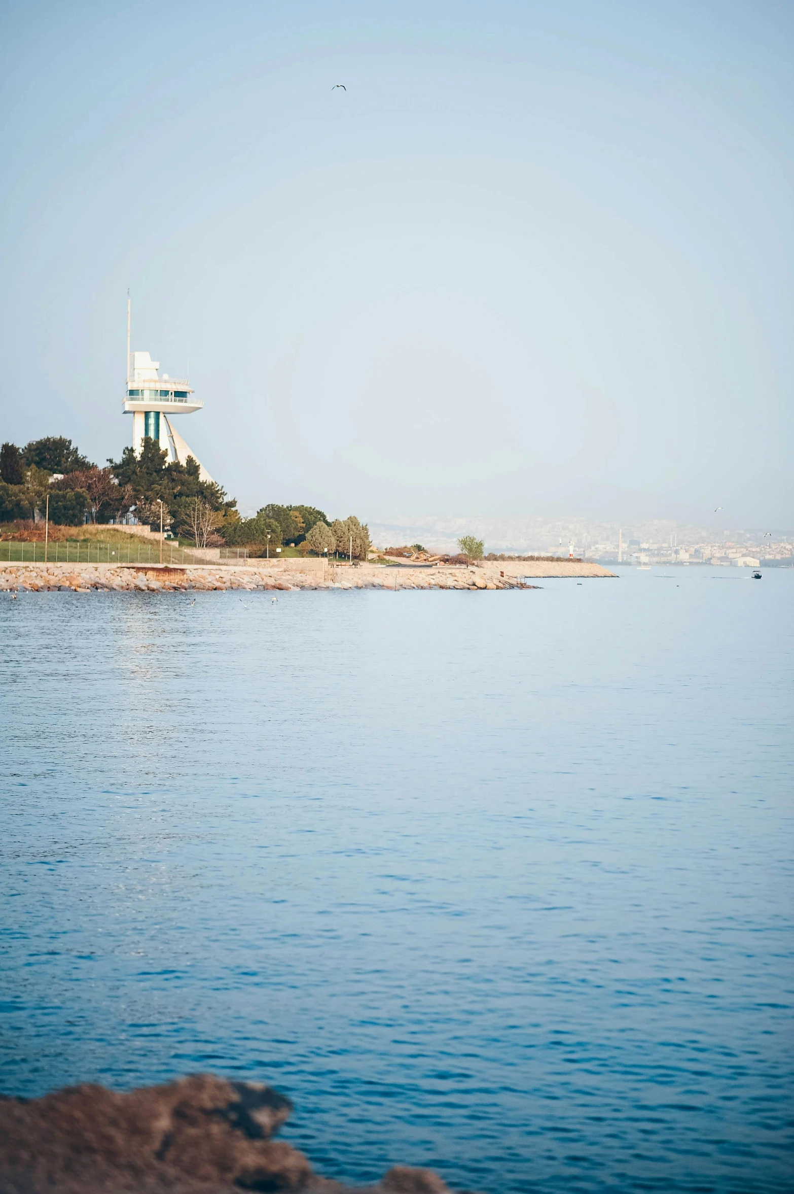 a blue ocean water with two light poles sticking out of the water