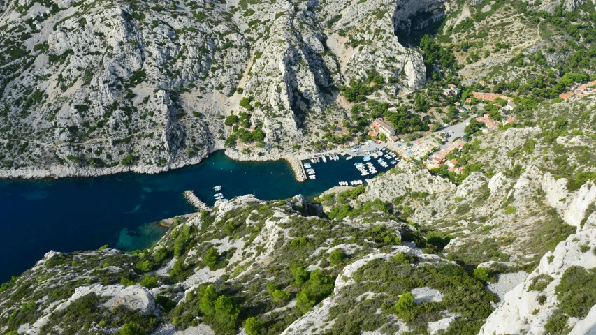 a boat yard with boats surrounded by mountains