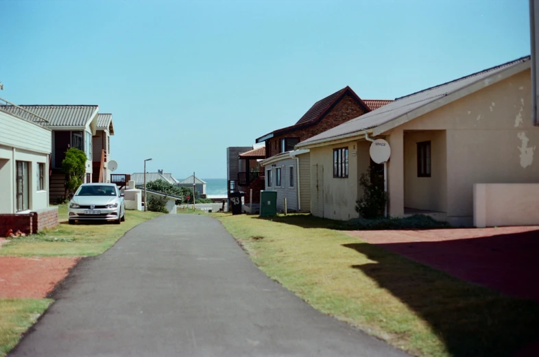 a long residential street with houses next to it