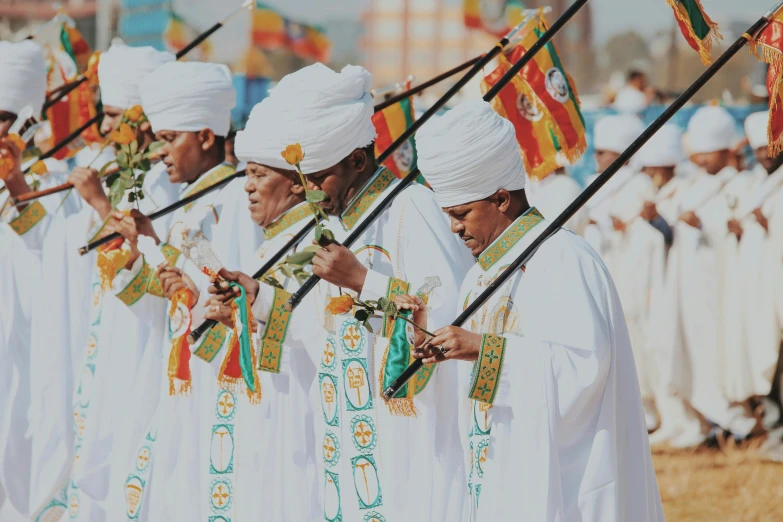 an indian marching band of white robes and white turbans performing