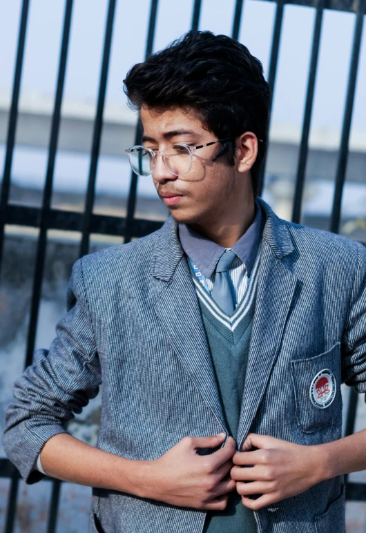 a man in glasses, a tie, and jacket