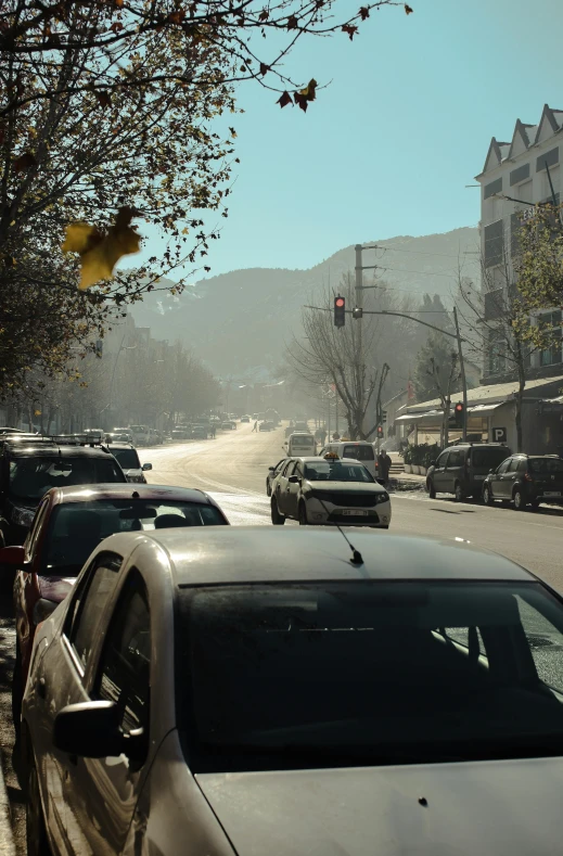 several cars driving down the road in a hilly area