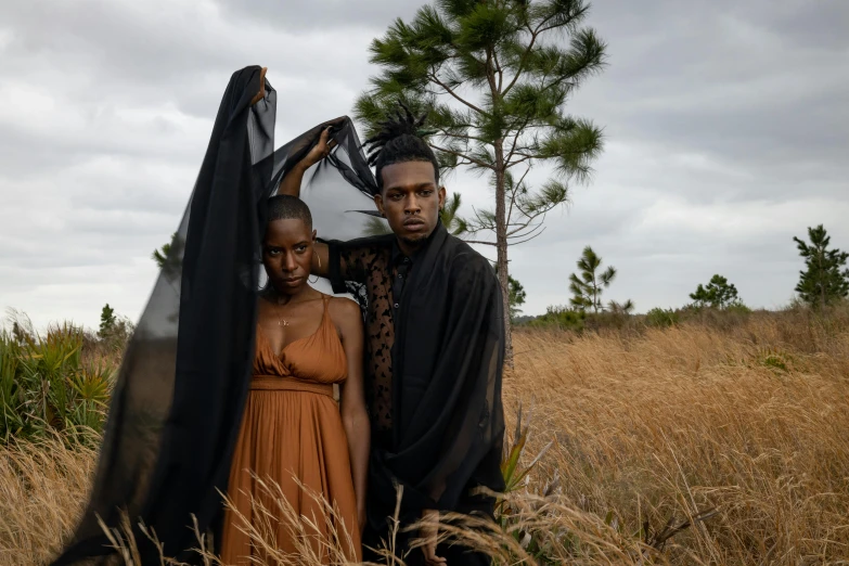 a man and woman in front of the same person on a field