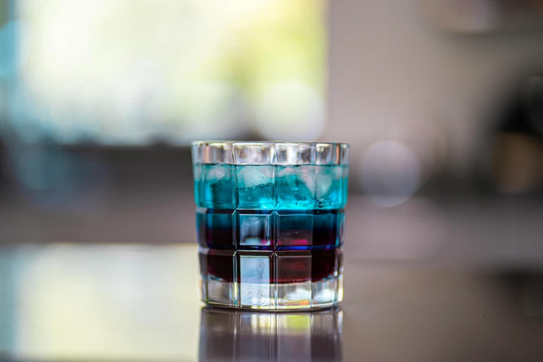 a small colorful s glass on a table