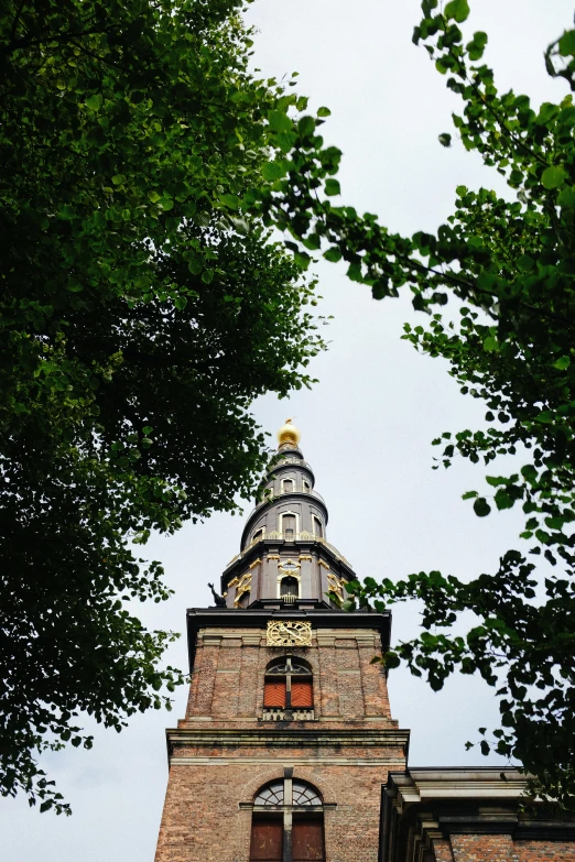 an old tower on top of a building, with clocks on the side