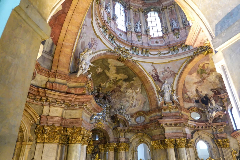 a large cathedral with paintings and vaulted ceiling