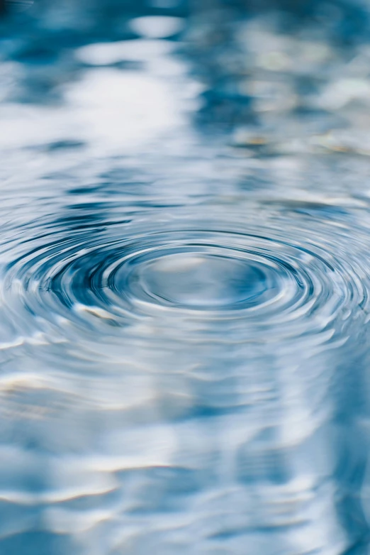 a water drop that is coming up from the water