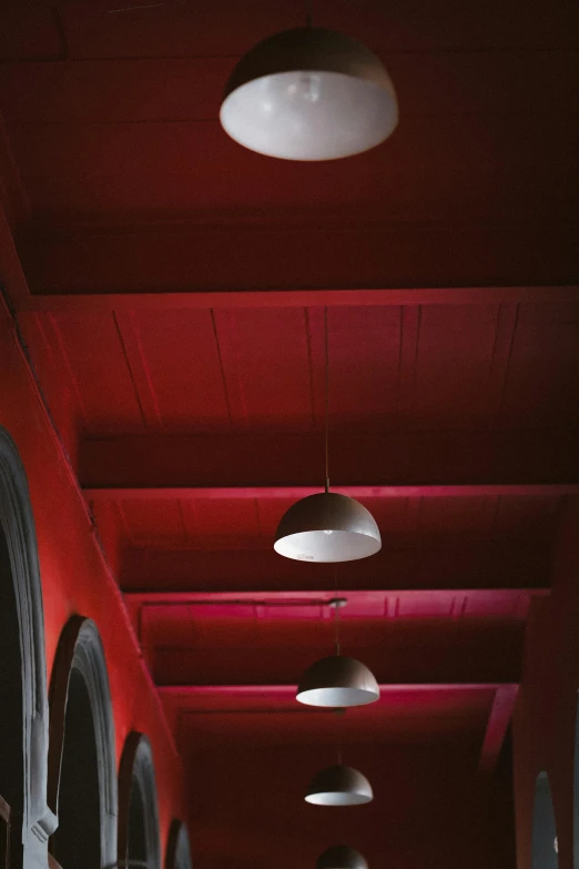 two lights hang from the ceiling while three other lights sit above