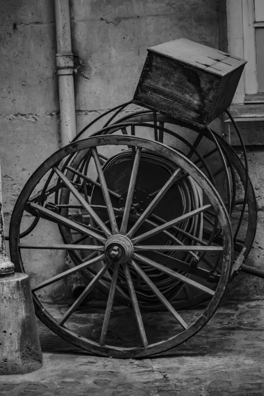 an old wooden wagon parked on the sidewalk