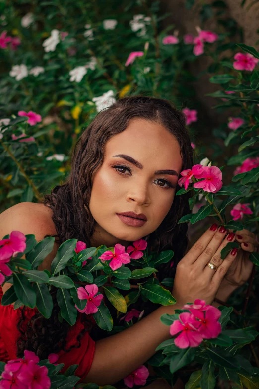 a young woman with flowery hair and blue eyes is surrounded by leaves