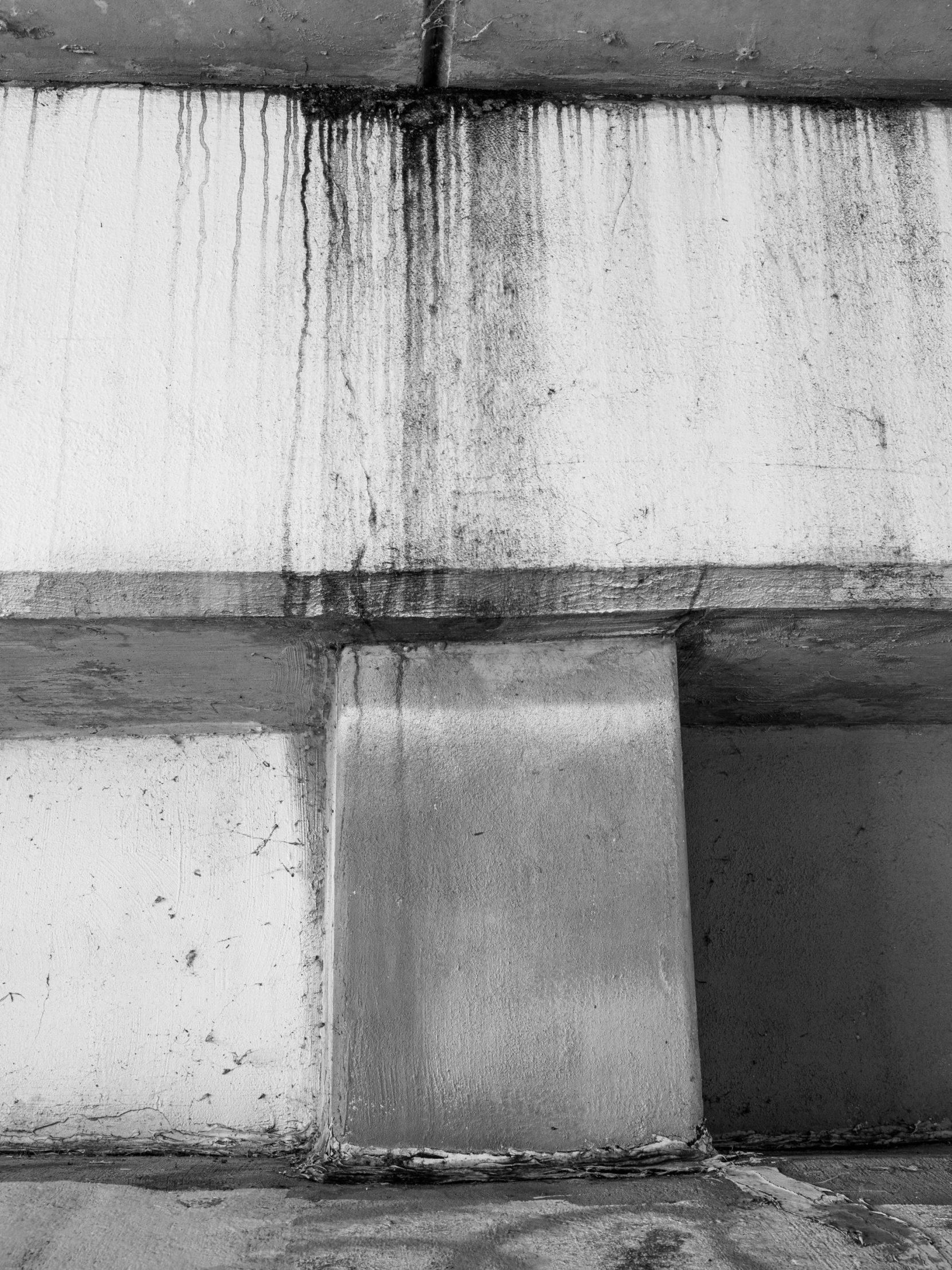 black and white pograph of a wall that has paint peeling off