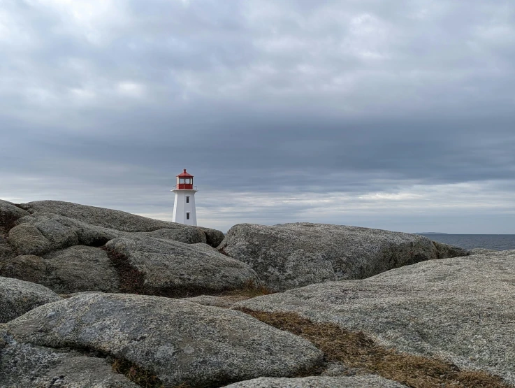 a light house on top of some large rocks