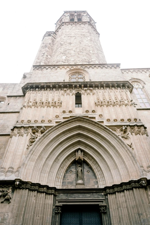 looking up at a tall gothic church with stone walls