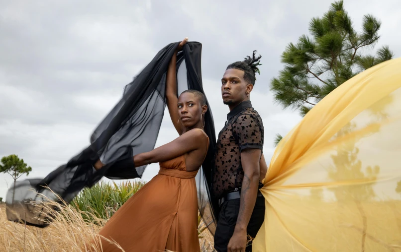 two people standing near each other in a field