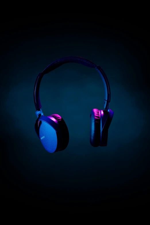 headphones are glowing purple on a black background