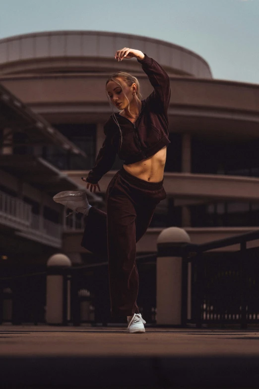 the woman has her arms spread out as she performs a dance