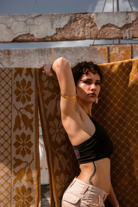 a woman leaning against the wall, arms above her head