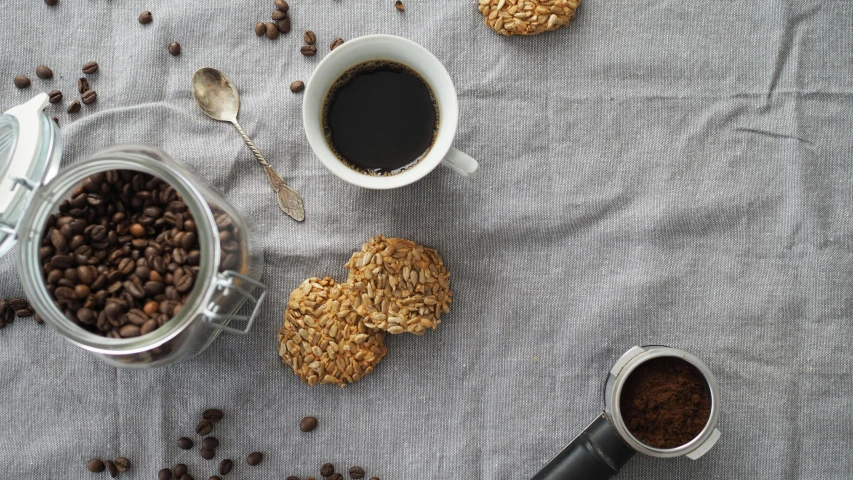 four cups of coffee are sitting on a cloth