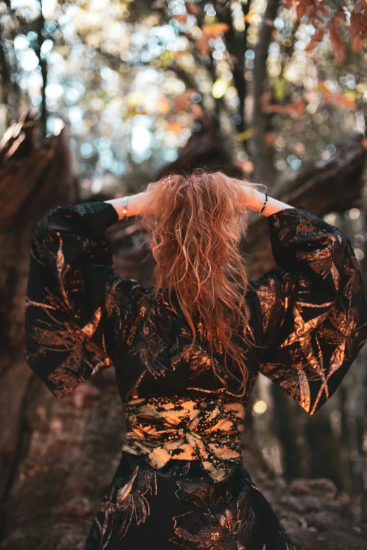 a woman that is standing in the woods