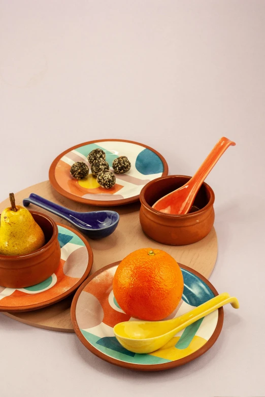 the fruits are on the colorful ceramic dishes