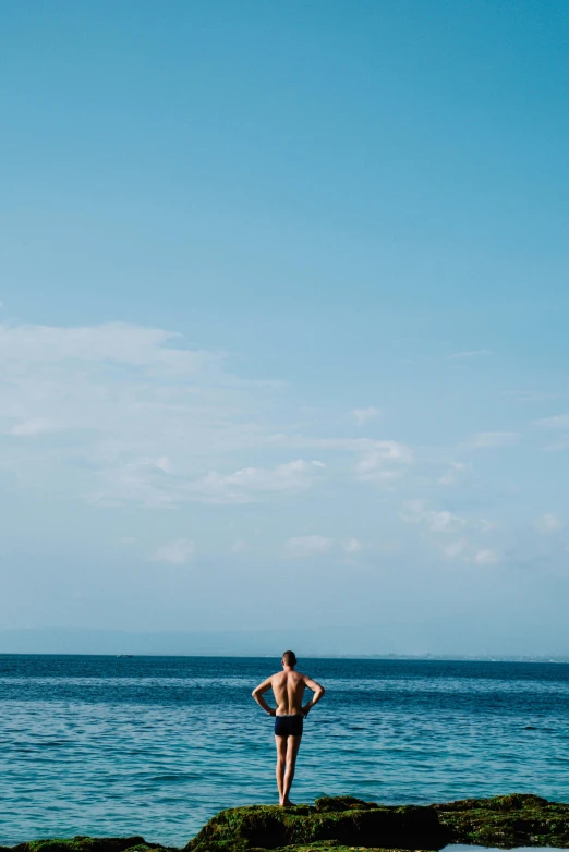 a person on a cliff by the ocean