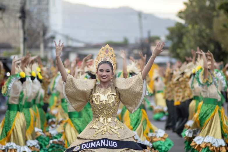 a parade of people in costume and colorful outfits