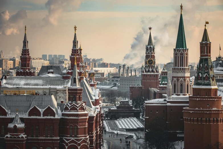 the city skyline is full of tall red and white towers