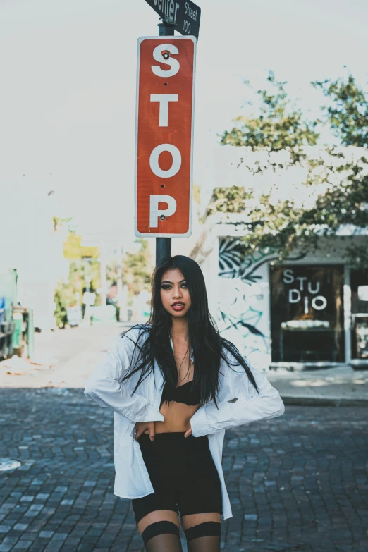 woman in black underwear posing with a street stop sign