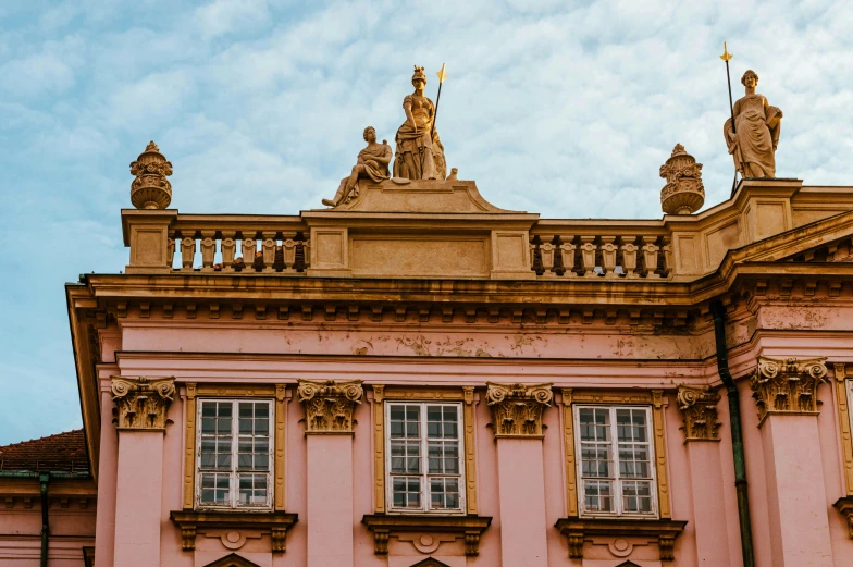 old pink building with a balcony on top