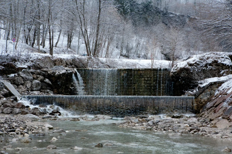 a waterfall sitting in the middle of a river