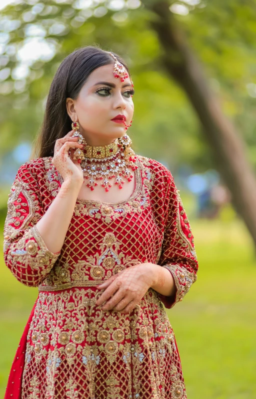 a woman in a bridal outfit is posing for the camera