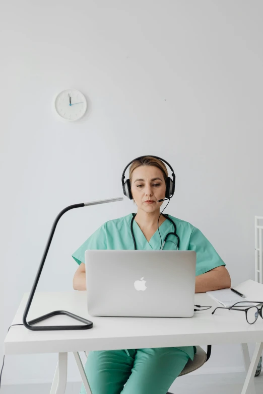 a girl in a green uniform is wearing headphones