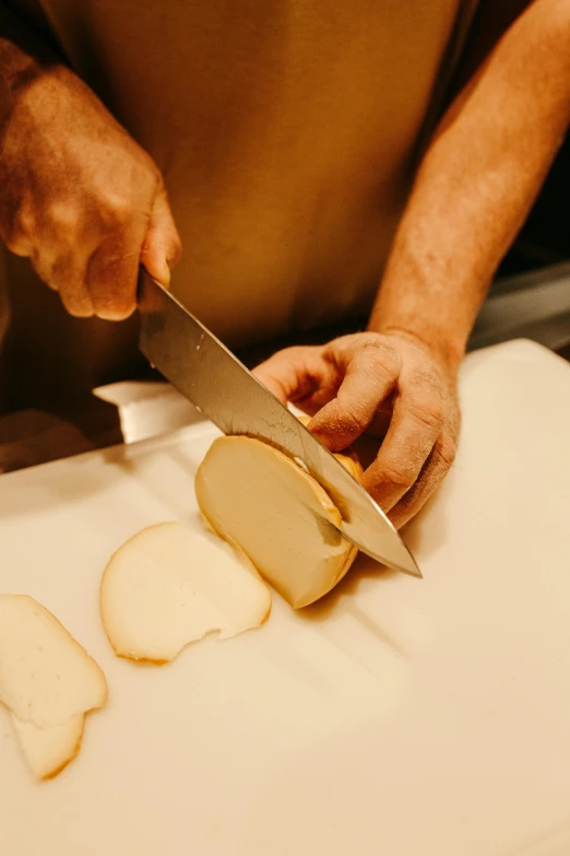 a man is slicing a bread on a  board