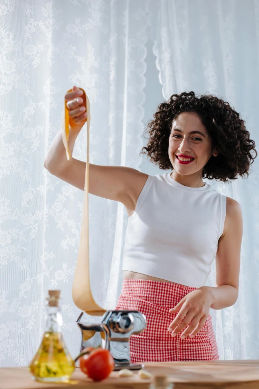 a woman wearing a red and white skirt is preparing a dish