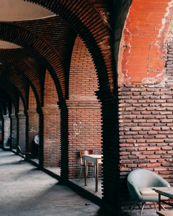 a long brick covered area with chairs