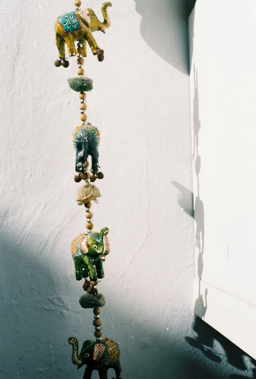 the colorful beads are hanging on the wall