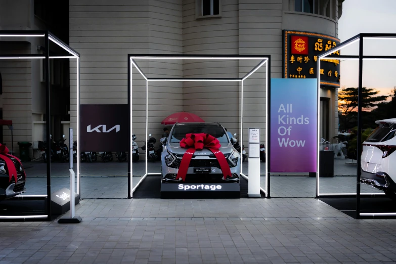 a display with red decorations and cars on the ground