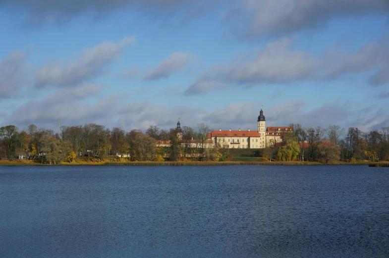 a house by the water on a cloudy day