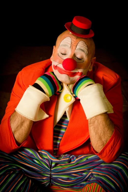 an image of clown with painted face and colorful clothing