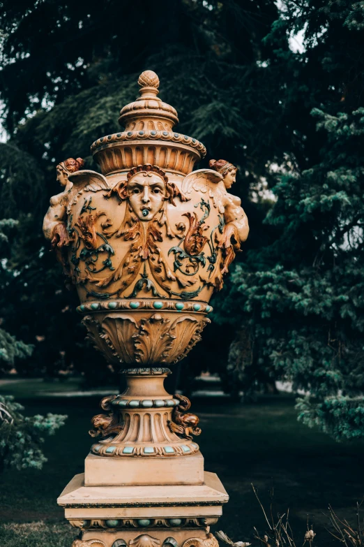 ornately decorated vase in a park setting