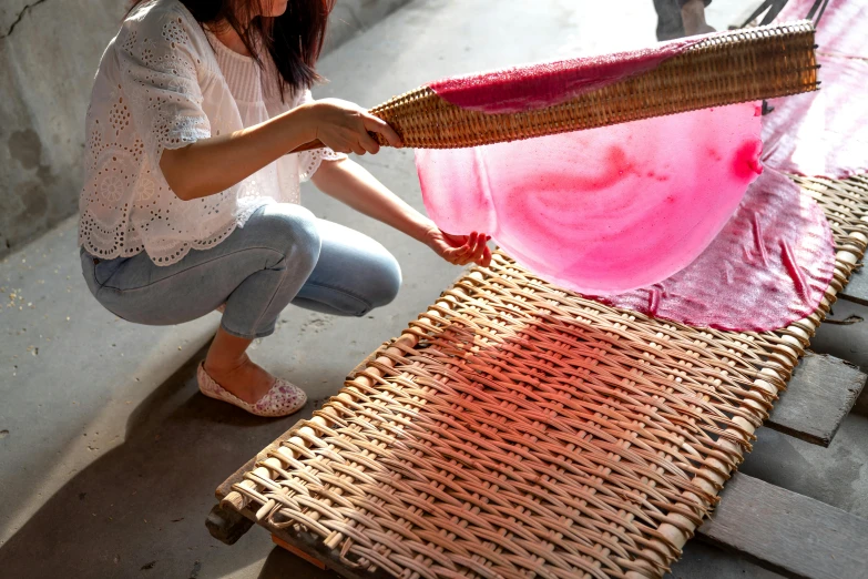 a woman is doing soing with pink dye