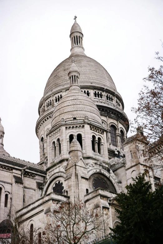 a tower of a building has steeple and pointy shapes