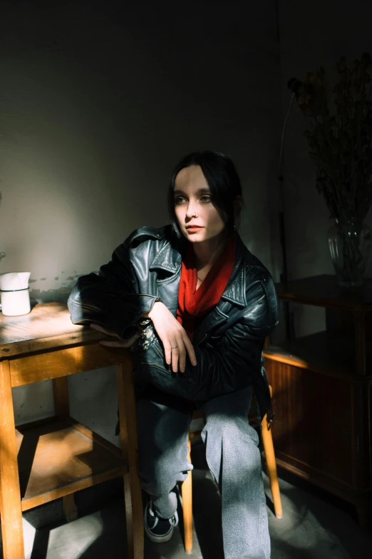 a woman sitting at a table with her arms crossed