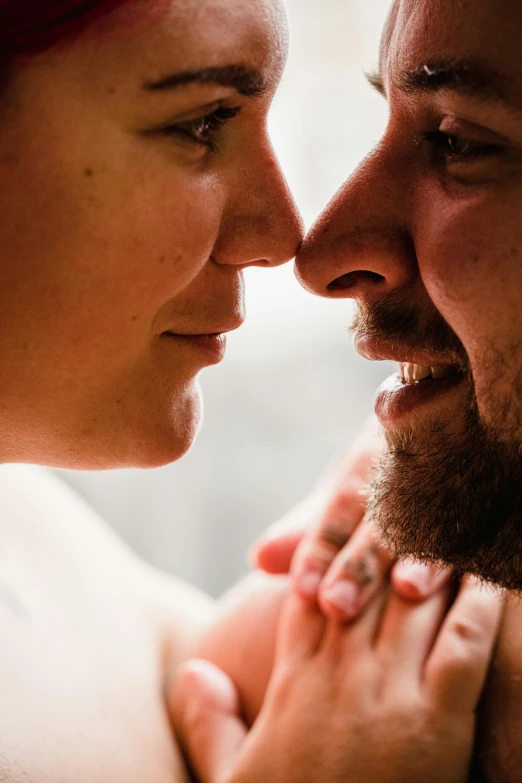 a couple of people standing close to each other