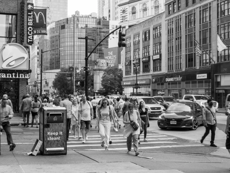 a busy city street with people walking across it