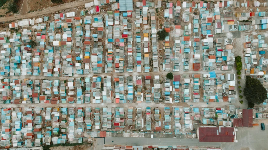 an aerial view of many identical rows of blue and orange buildings