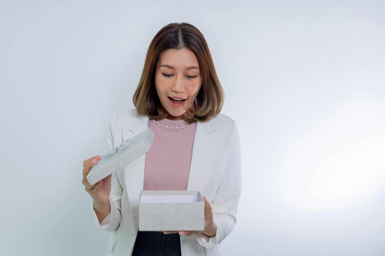 a woman with a box in her hands looks like she could win the prize