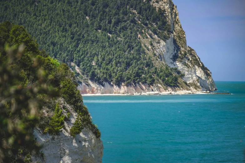 a boat near a large mountain with a small island