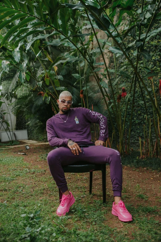 a woman in pink is sitting on a chair